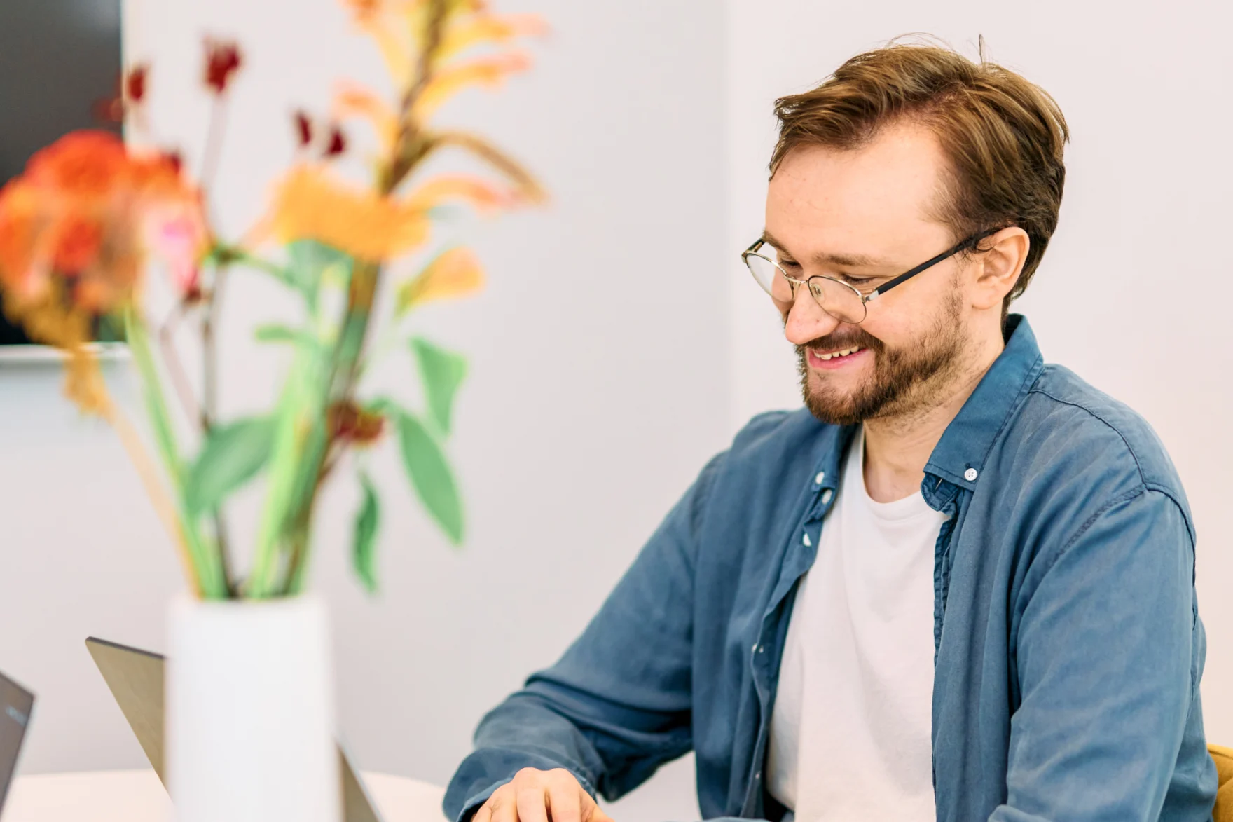 Mars web designer smiling while reviewing a design on his laptop