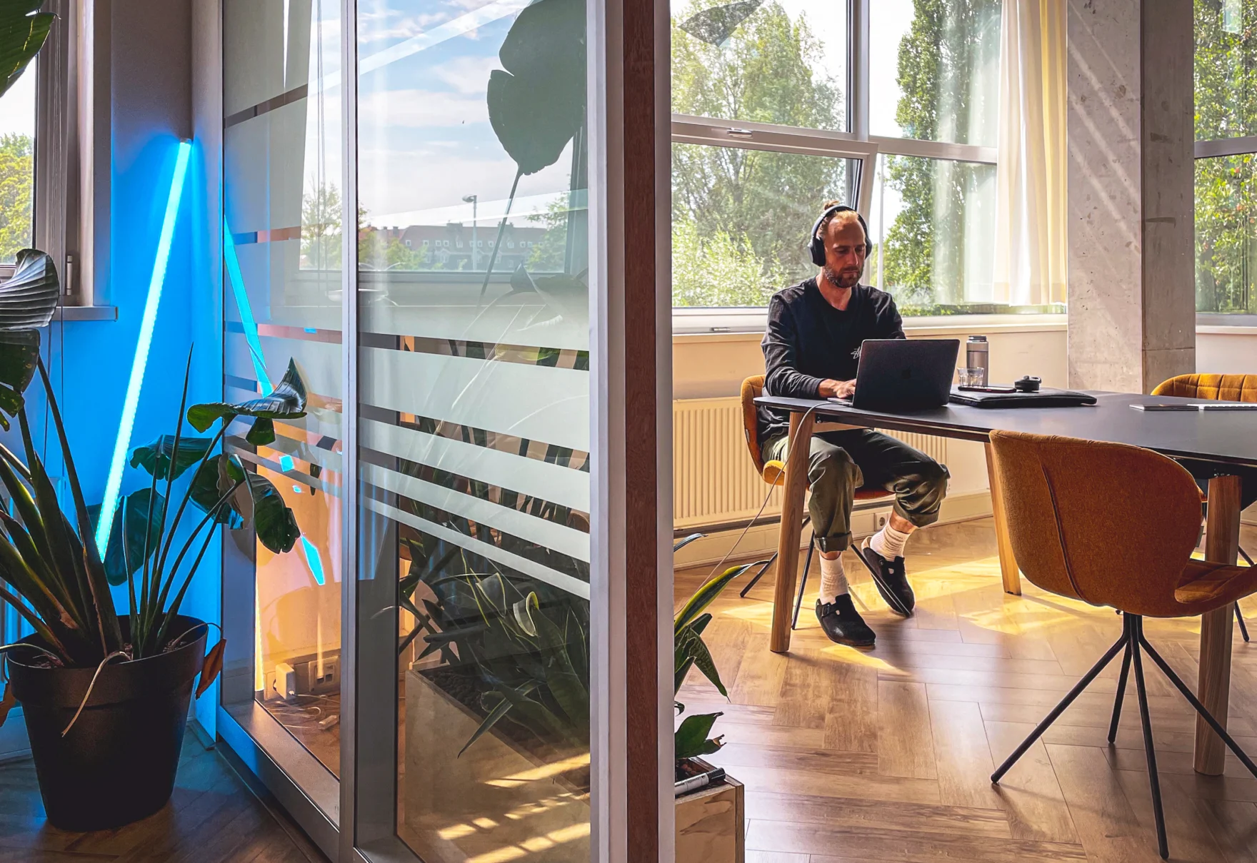Mars employee working on a laptop at a sunlit office desk