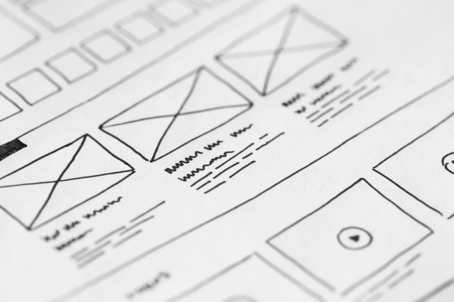 Close-up of a hand-drawn website wireframe sketch on paper