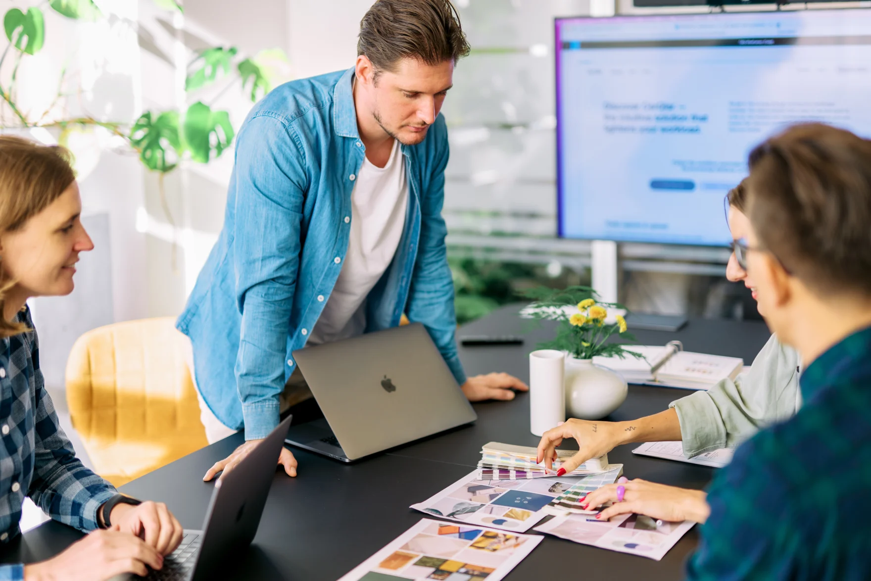Mars team reviewing brand color swatches and website mockups during a design meeting