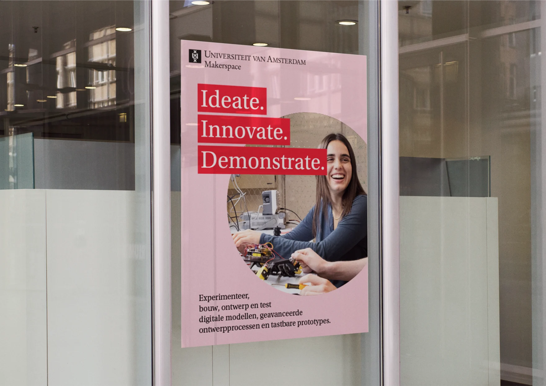 Close-up of the UvA Makerspace poster on glass, showing a student soldering a robotic device