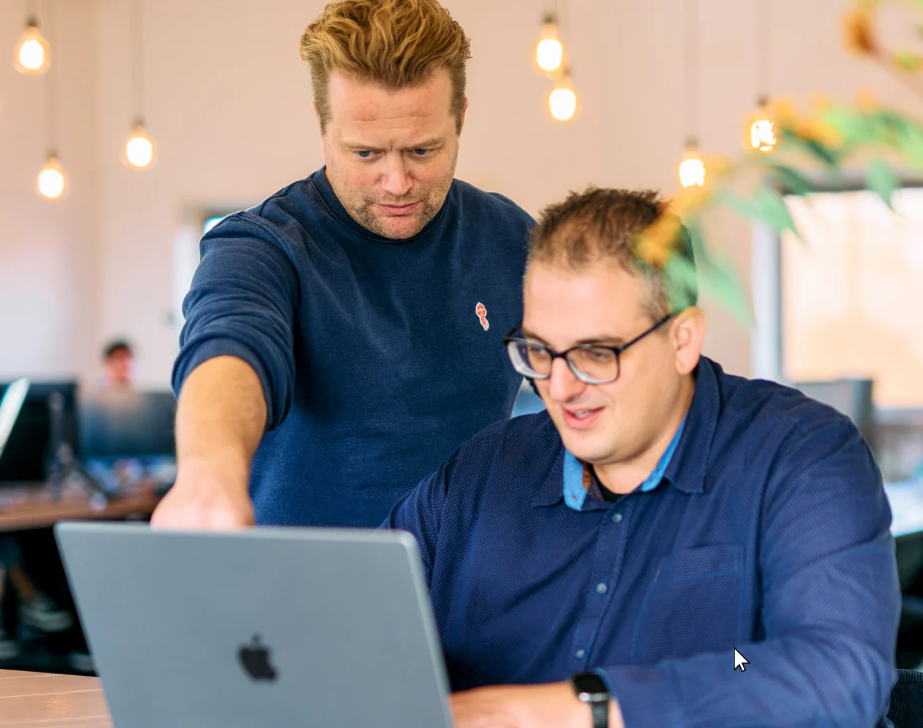 Two Mars colleagues reviewing a project together on a laptop in the office