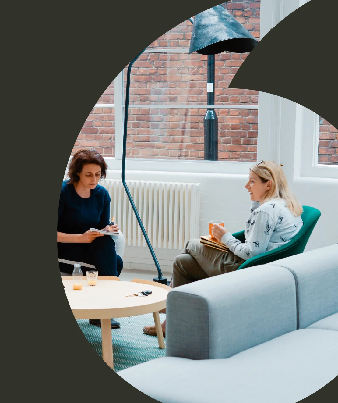 Stampa brand shape framing two colleagues in a meeting at the office