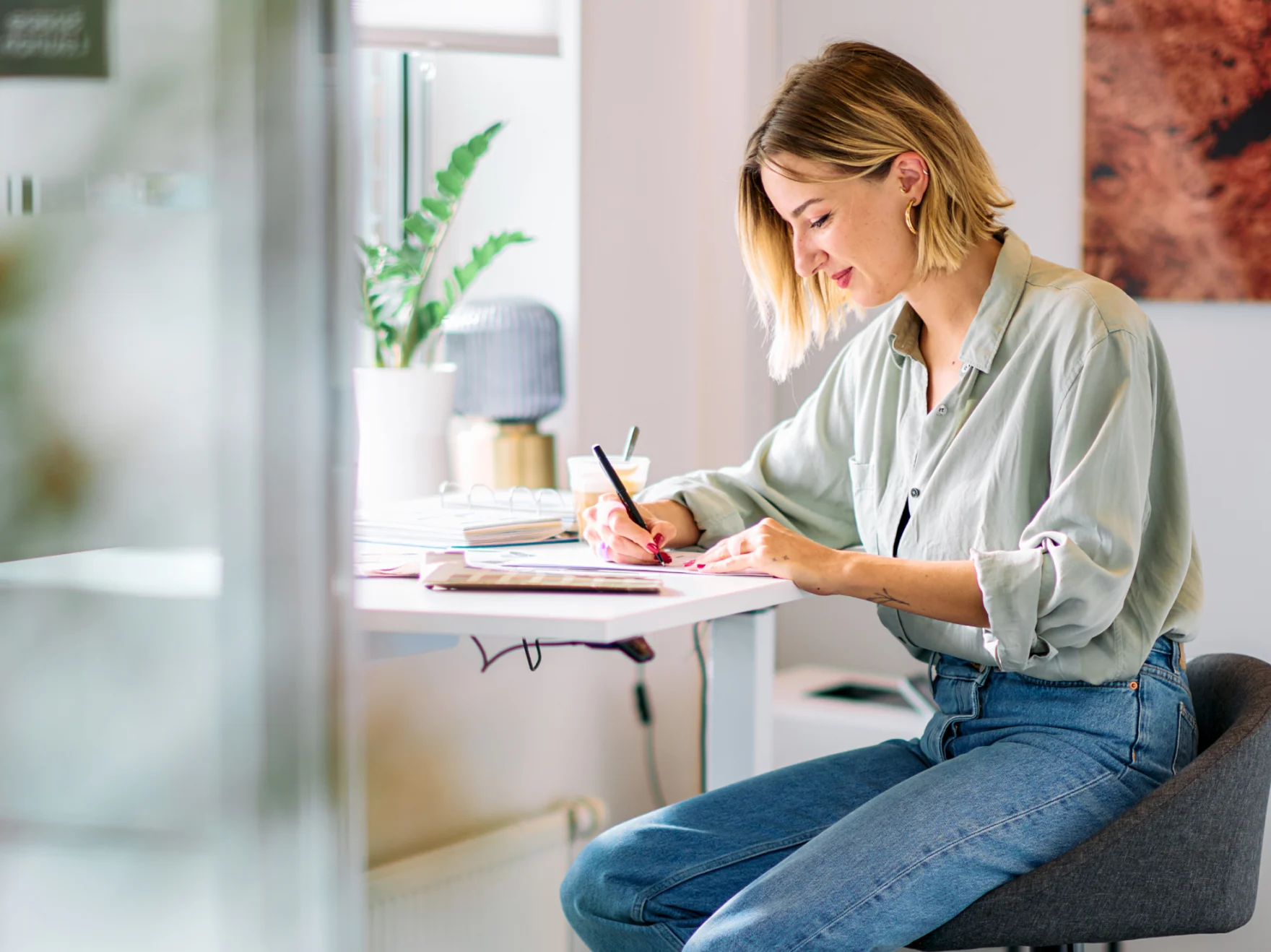Mars employee writing notes at a sunlit office desk