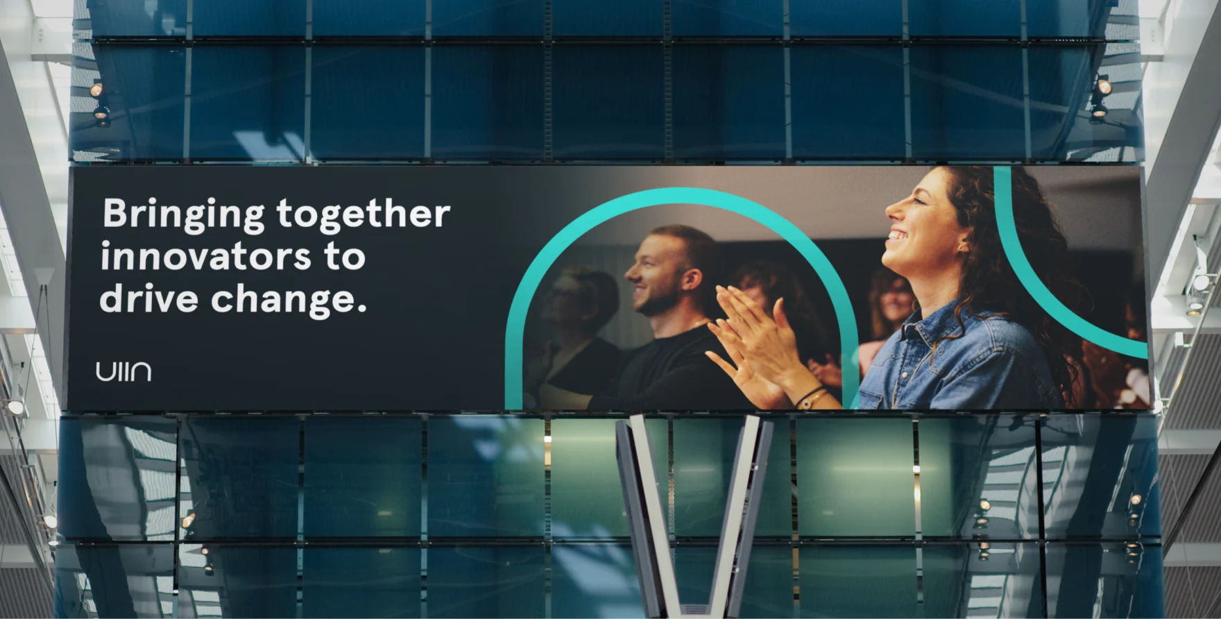 Large UIIN atrium banner with the tagline bringing together innovators to drive change