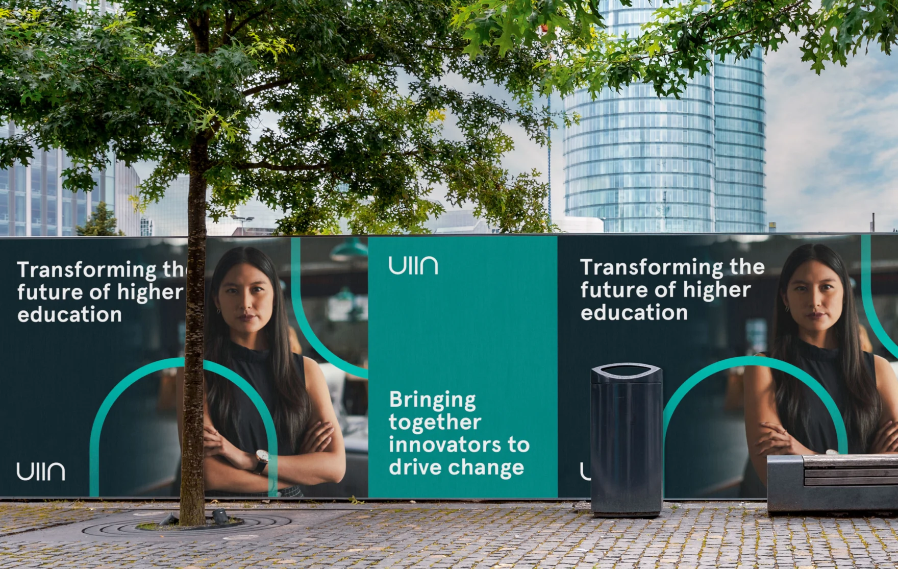 UIIN branded poster wall mockup on a city street with teal arch graphics