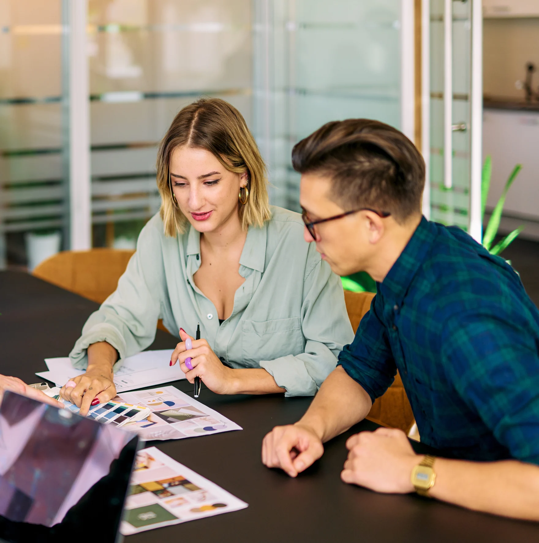 Designers reviewing color swatches and mood boards for a visual identity project