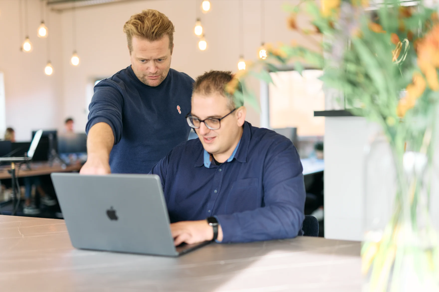 Two Mars colleagues discussing campaign strategy together at a shared desk