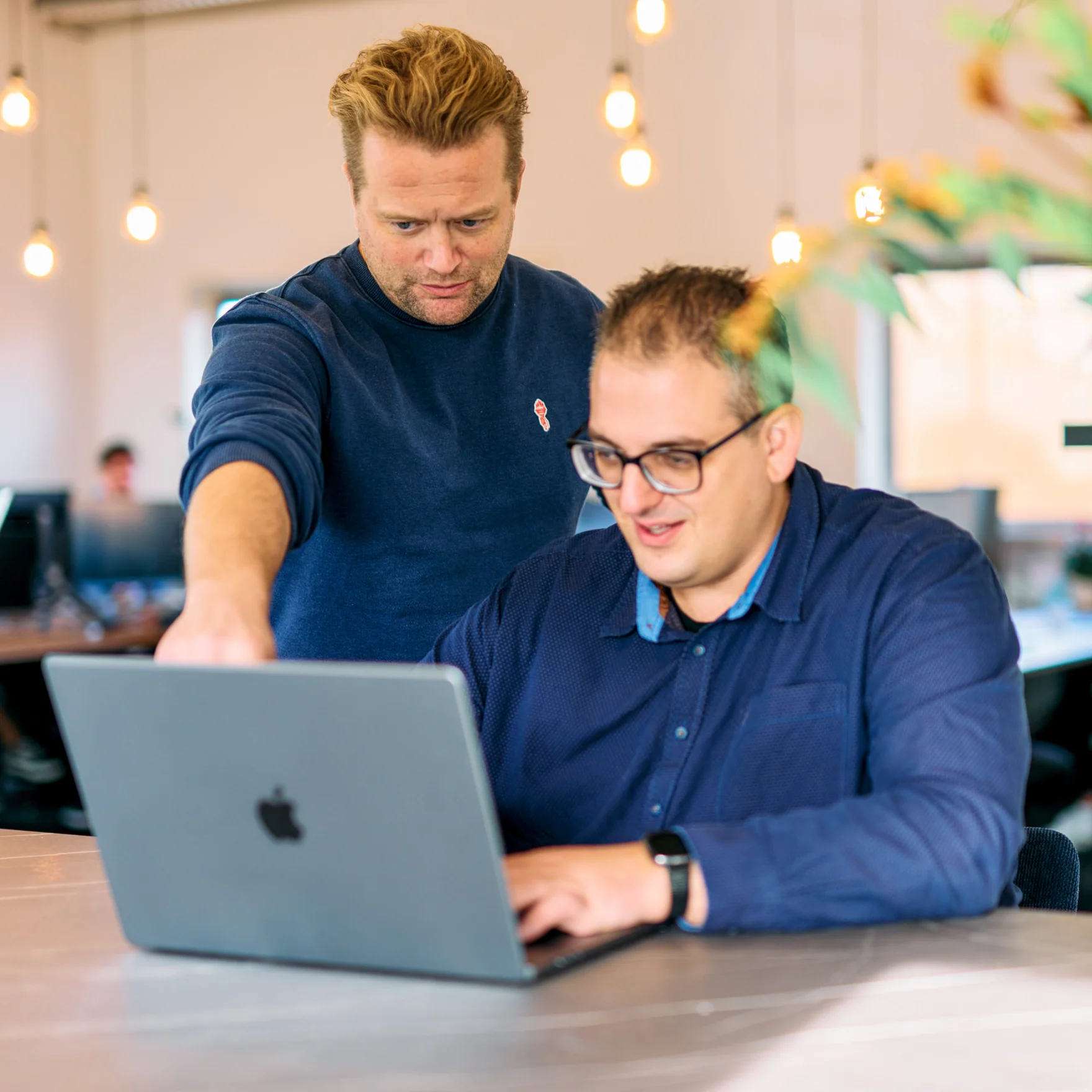 Two Mars colleagues collaborating on a website project at the office