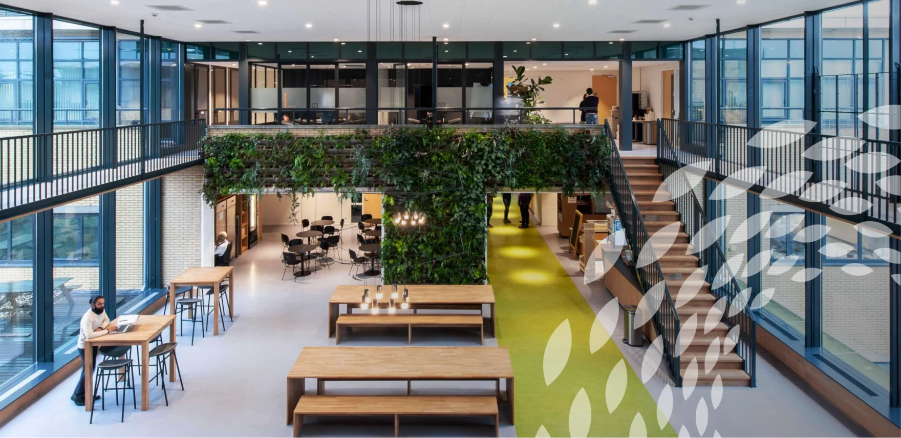 Modern Avantium office interior with a green plant wall and open staircase