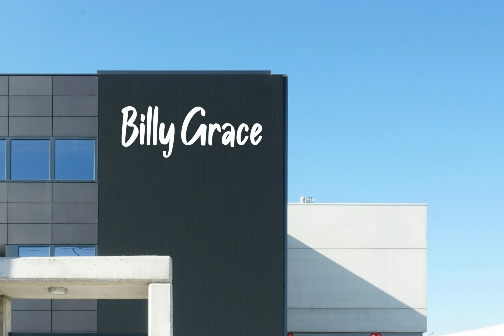 Billy Grace logo signage mounted on a modern office building