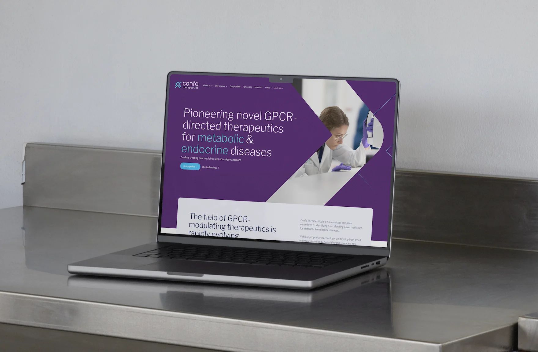 Laptop on a countertop displaying the Confo Therapeutics website homepage designed by Mars