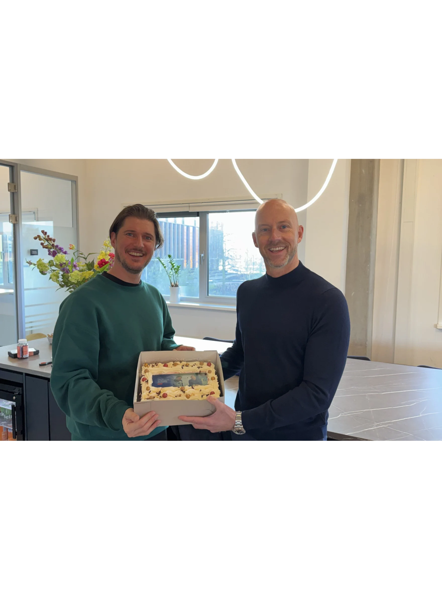Team members celebrating ten years of the Solventa partnership with a cake