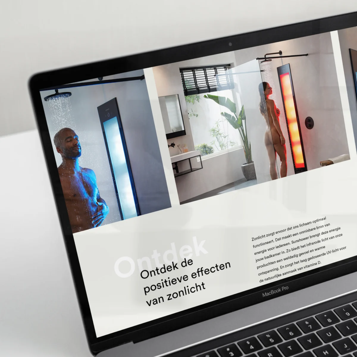 Laptop screen showing the Sunshower website with light therapy shower panels in a bathroom