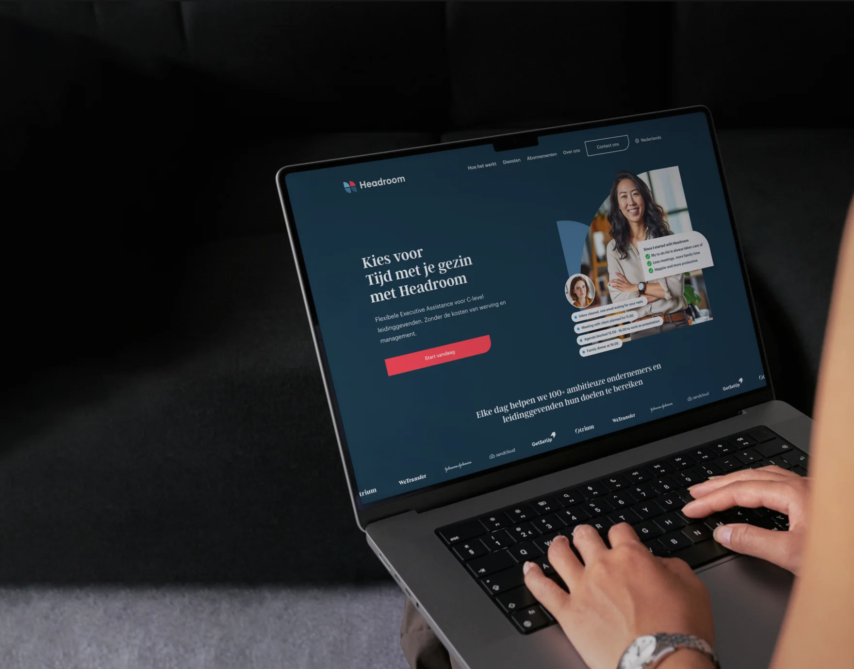 Person typing on a laptop displaying the Headroom executive assistant homepage