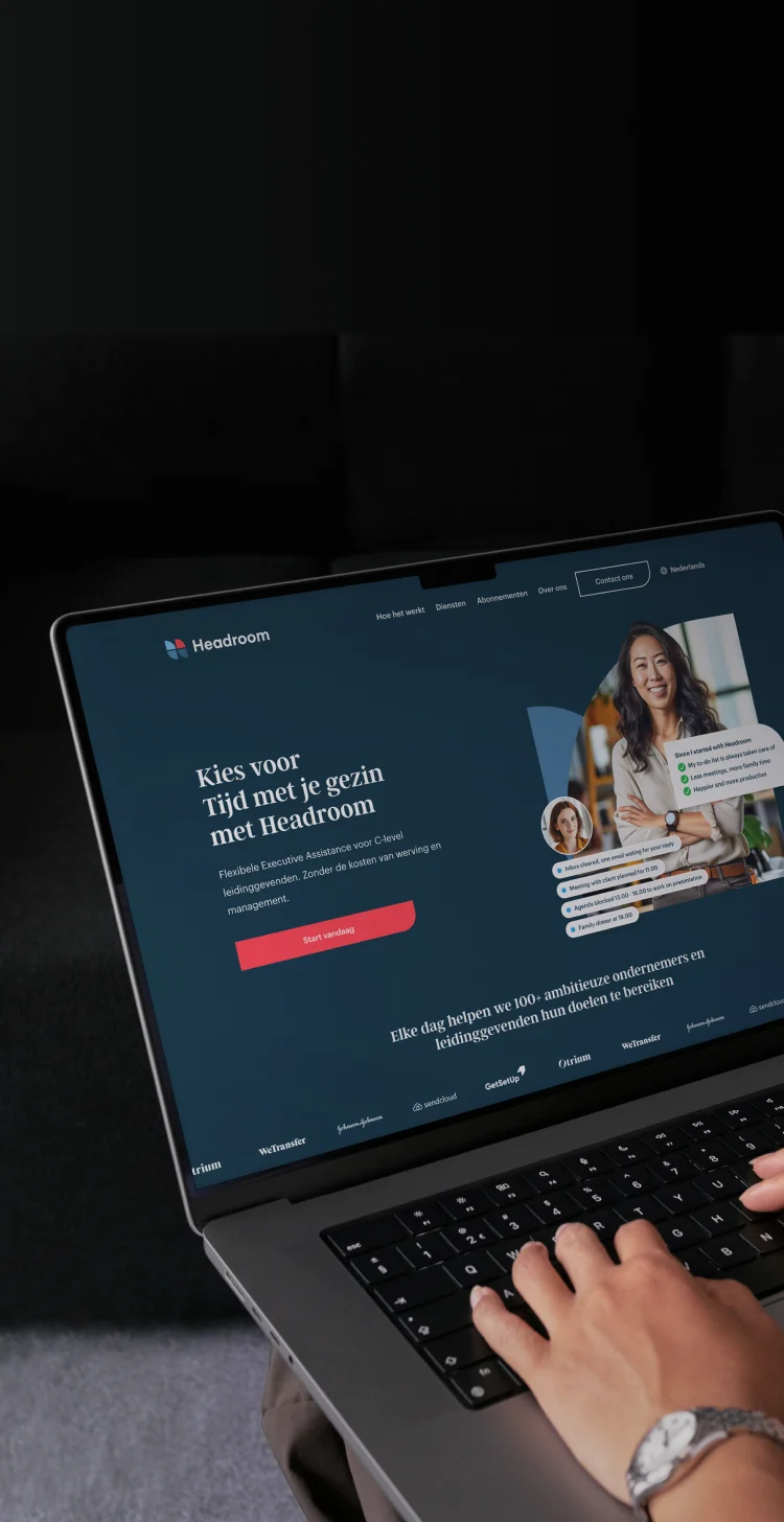 Mobile header photo of a person typing on a laptop showing the Headroom website