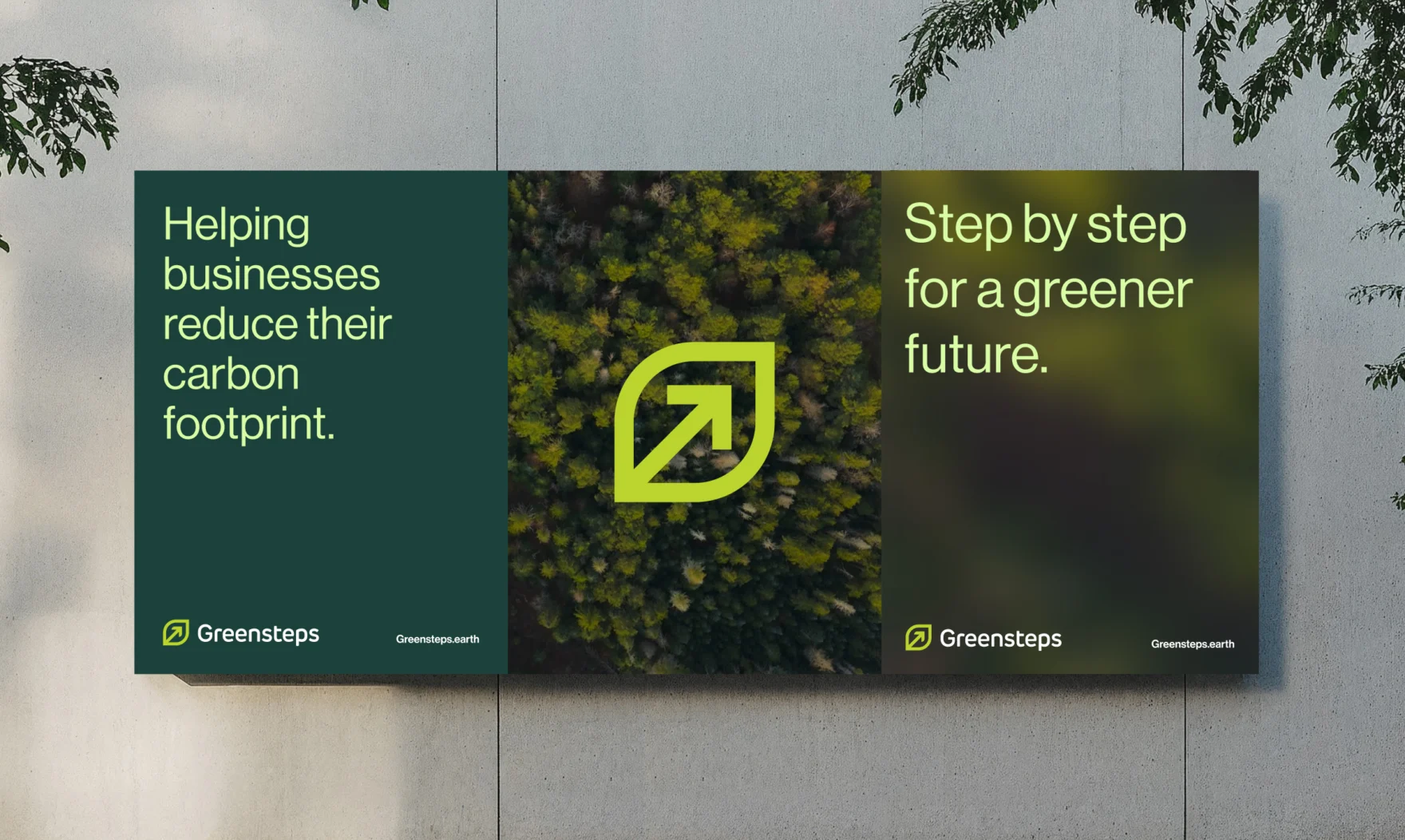 Billboard mockup with Greensteps branding and sustainability slogans on a concrete wall.