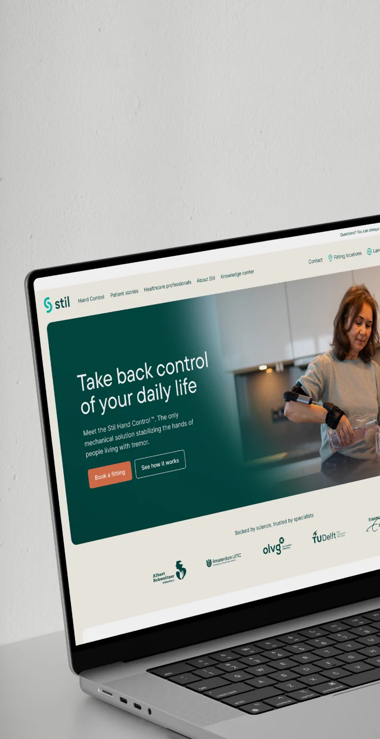 Laptop displaying the homepage of the Stil website.
